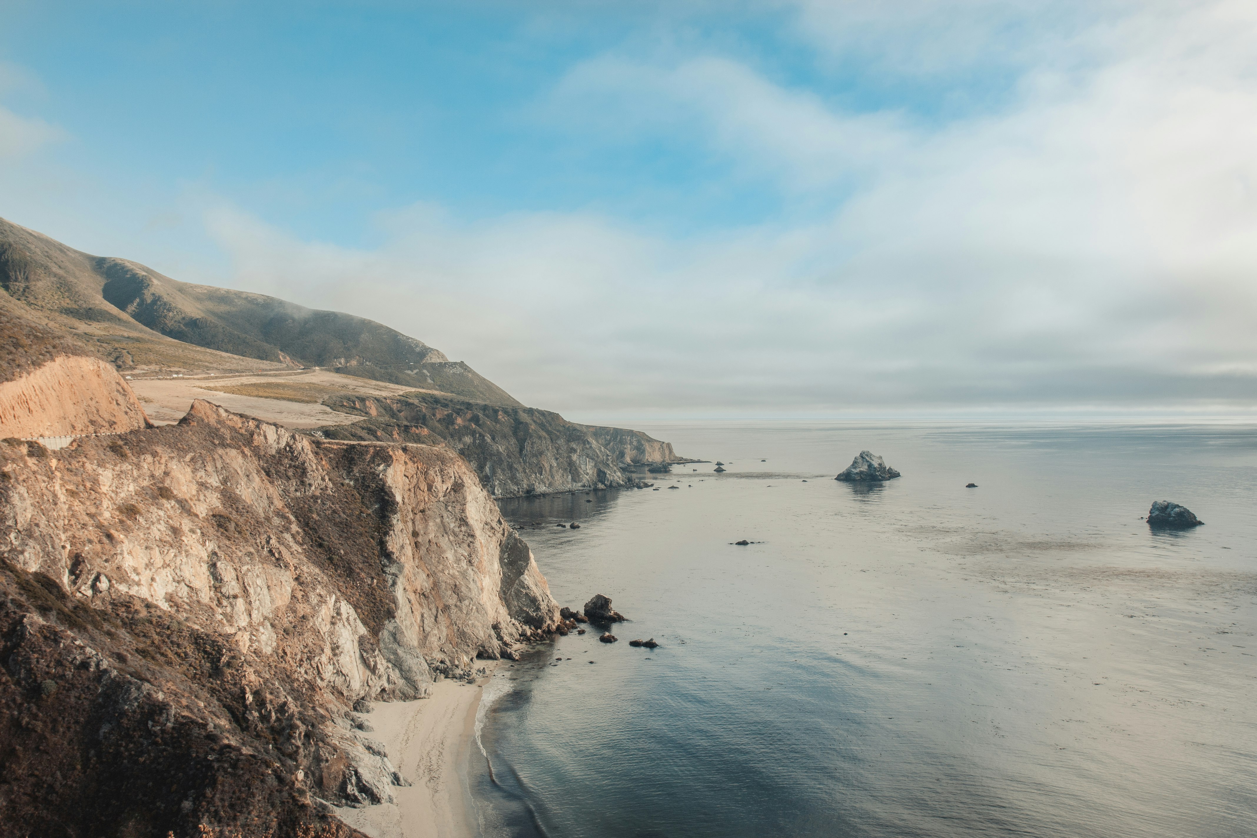 gray and brown cliff near the ocean